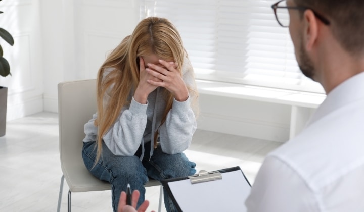 woman crying on a chair